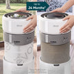 Levoit HEPA replacement filter installed in air purifier, shown with hands