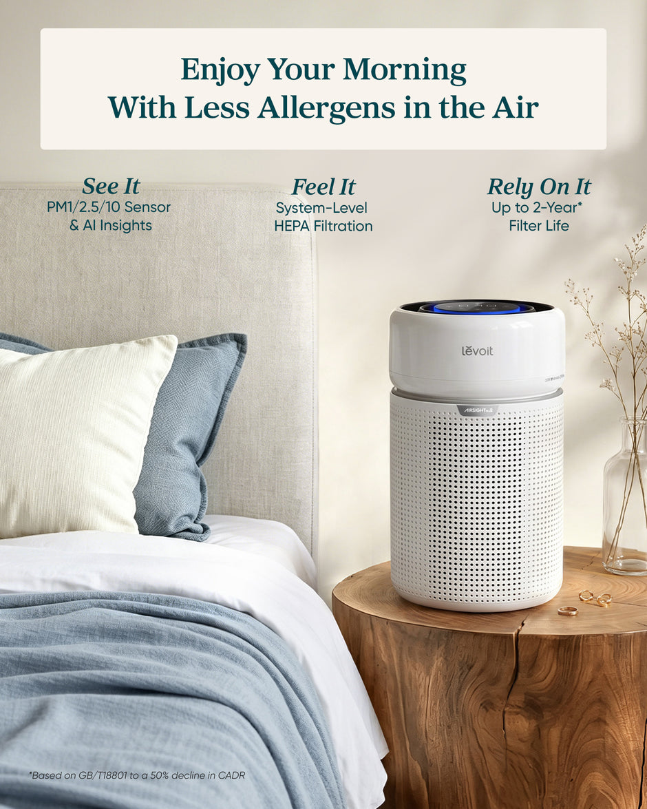 White air purifier with blue LED control panel on a wooden side table