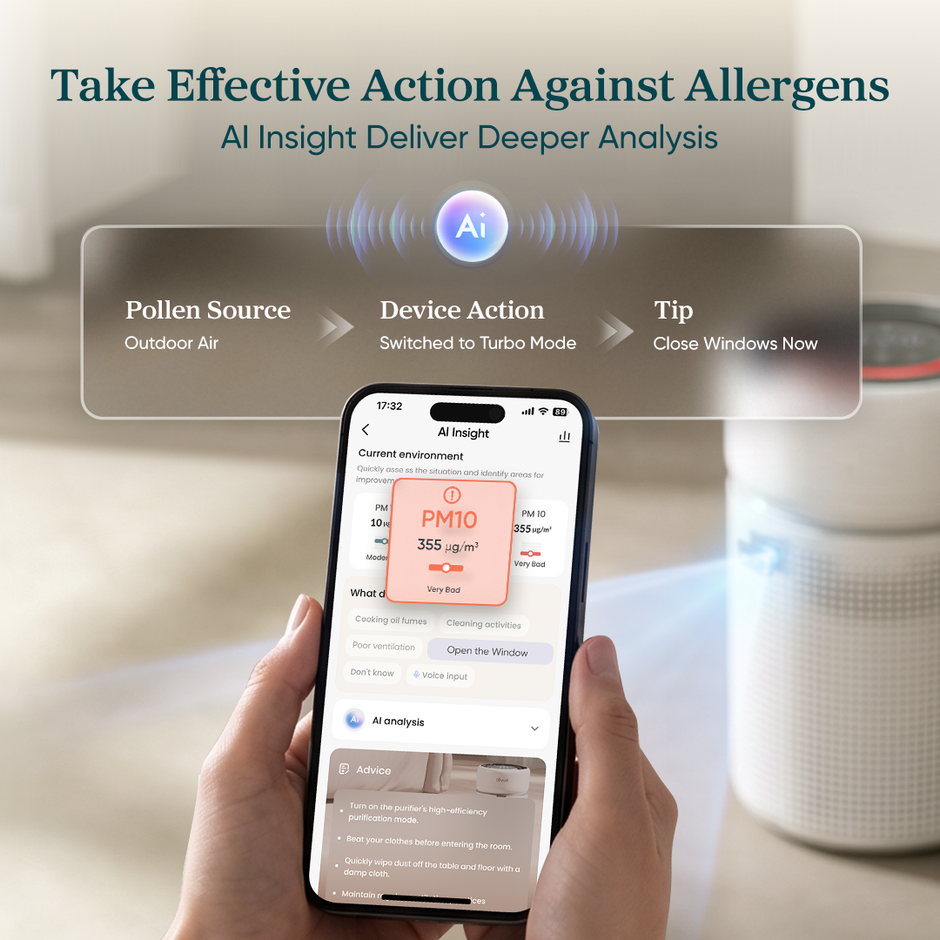 White Levoit air purifier with hands holding a smartphone showing air-quality readings
