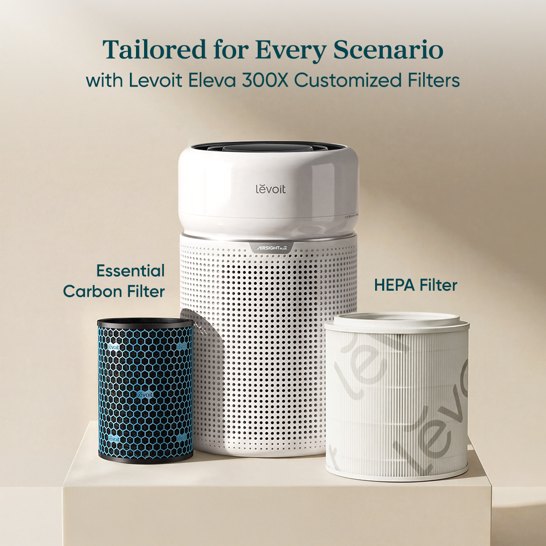 White Levoit air purifier with essential carbon and HEPA replacement filter canisters