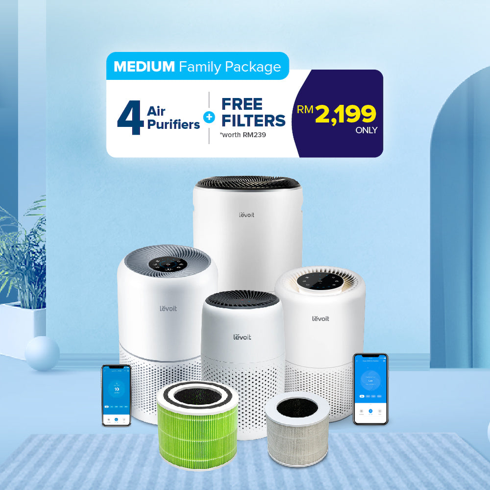 Four white Levoit air purifiers with green and gray filter cartridges