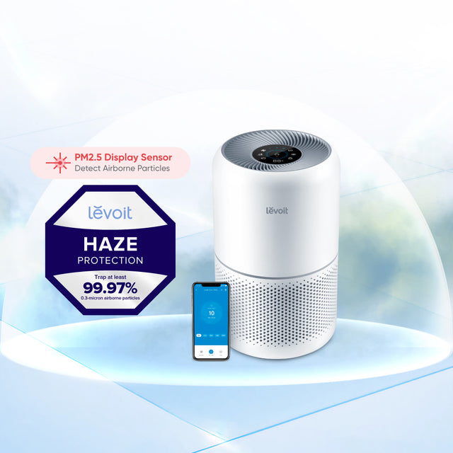 White Levoit smart air purifier with top control panel and circular vent grilles