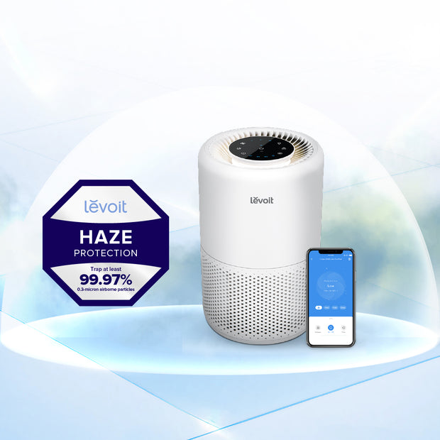 Levoit Core 200S air purifier, white cylinder with top control and app on phone